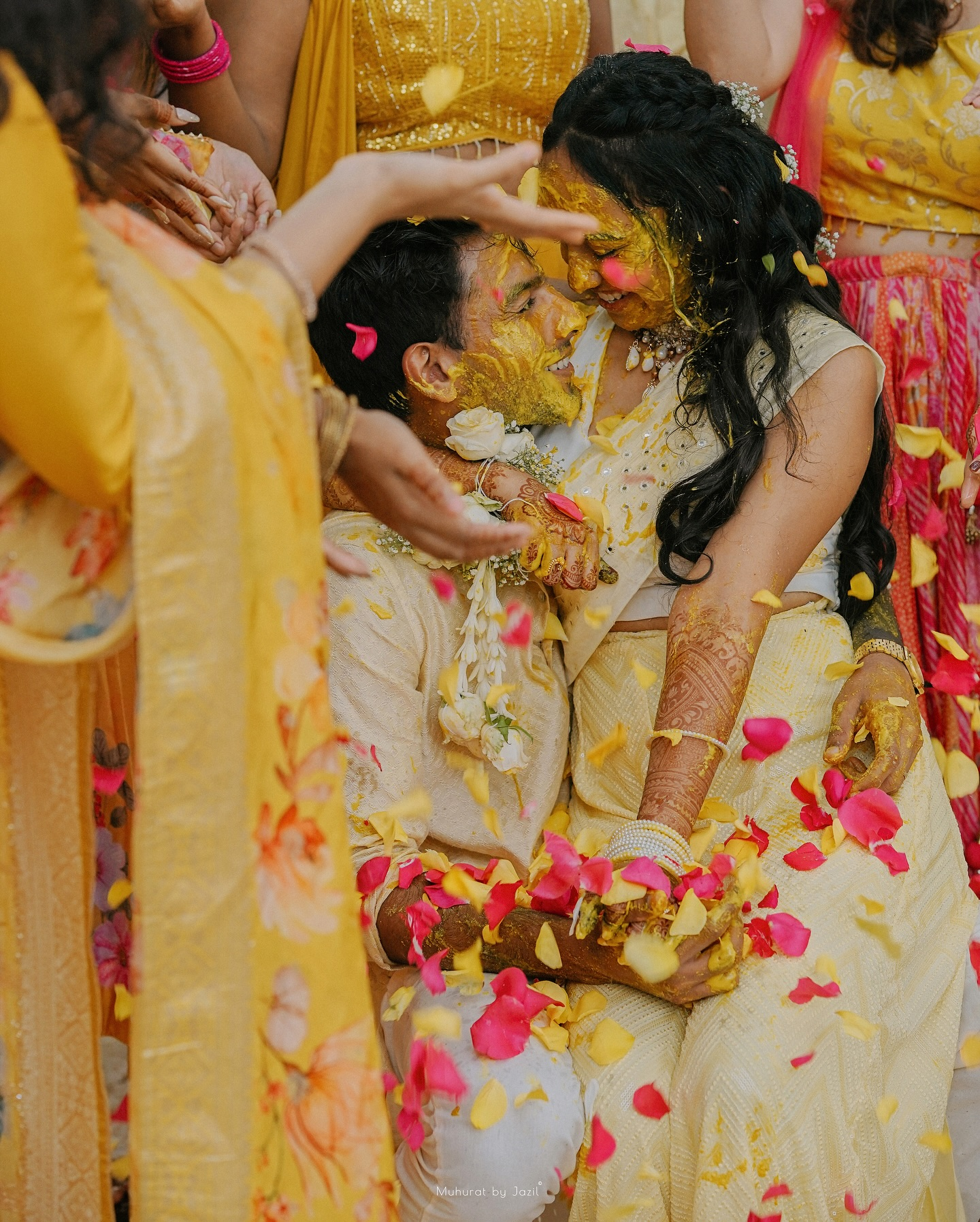 A couple sharing a playful moment during their haldi celebration